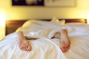 sleeping in with feet sticking out from under covers