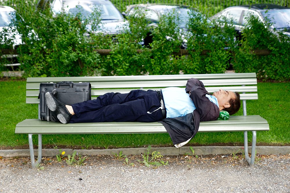 man napping on park bench
